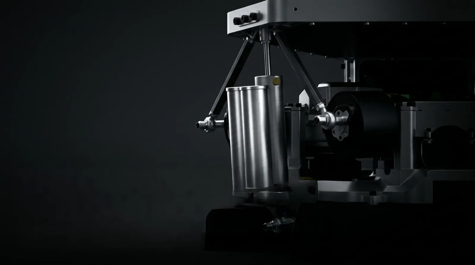 Close-up of one pneumatic leg: the twin ballast tanks and their cylinder carrying the platform's static load, with a direct-drive motor and con rods behind them